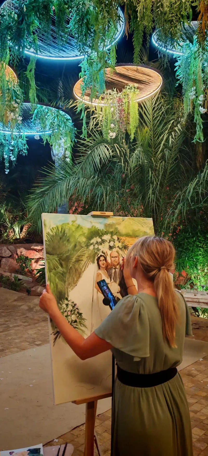 Artist Marta painting live at a luxury garden wedding venue in Marbella, Spain