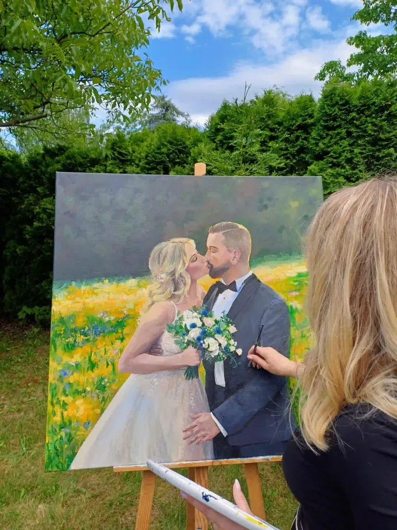 Artist Marta painting the bride and groom live at an outdoor garden wedding in Spain